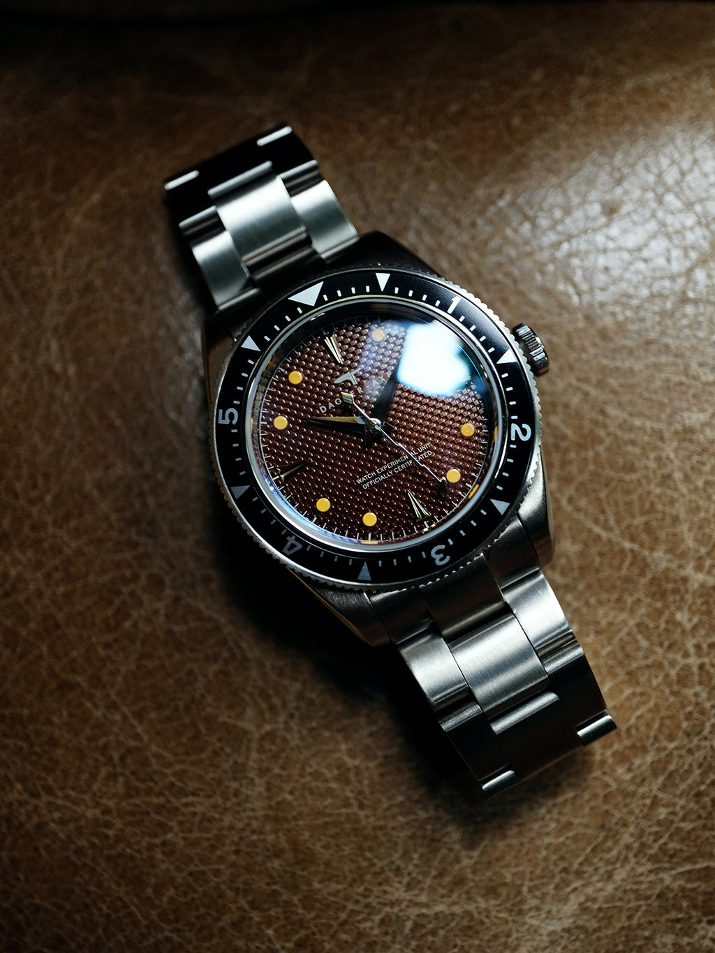 DAGGER A.X.E. Brown Dial watch close-up showing tropical brown dial and gold hour markers
