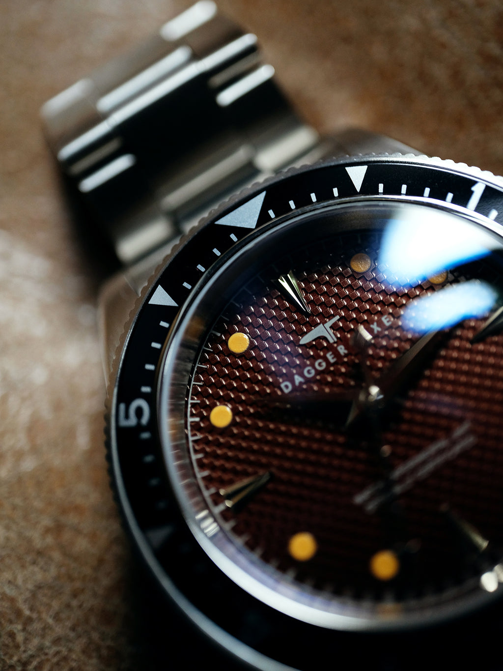 DAGGER A.X.E. Brown Dial vintage dive watch flat lay on textured surface