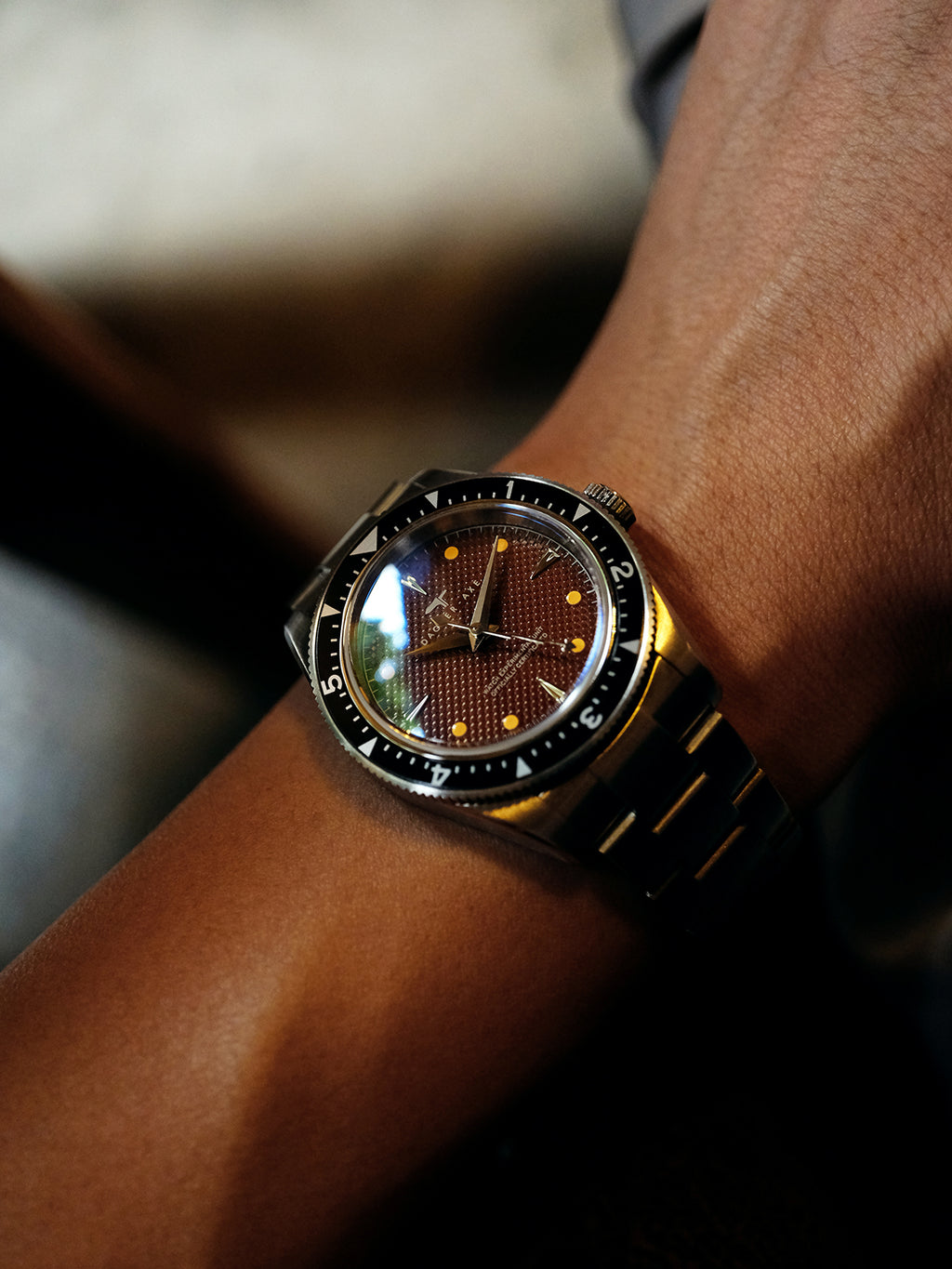 DAGGER A.X.E. Brown Dial watch angle shot showing sapphire crystal dome and brown dial