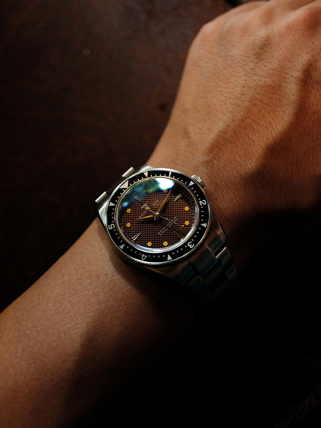 DAGGER A.X.E. Brown Dial vintage watch with stainless steel bracelet on dark background