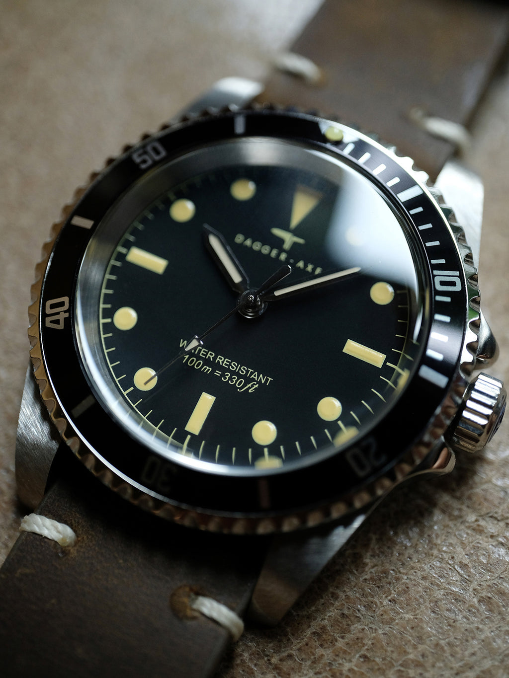 DAGGER A.X.E. MK1 vintage dive watch flat lay on textured surface